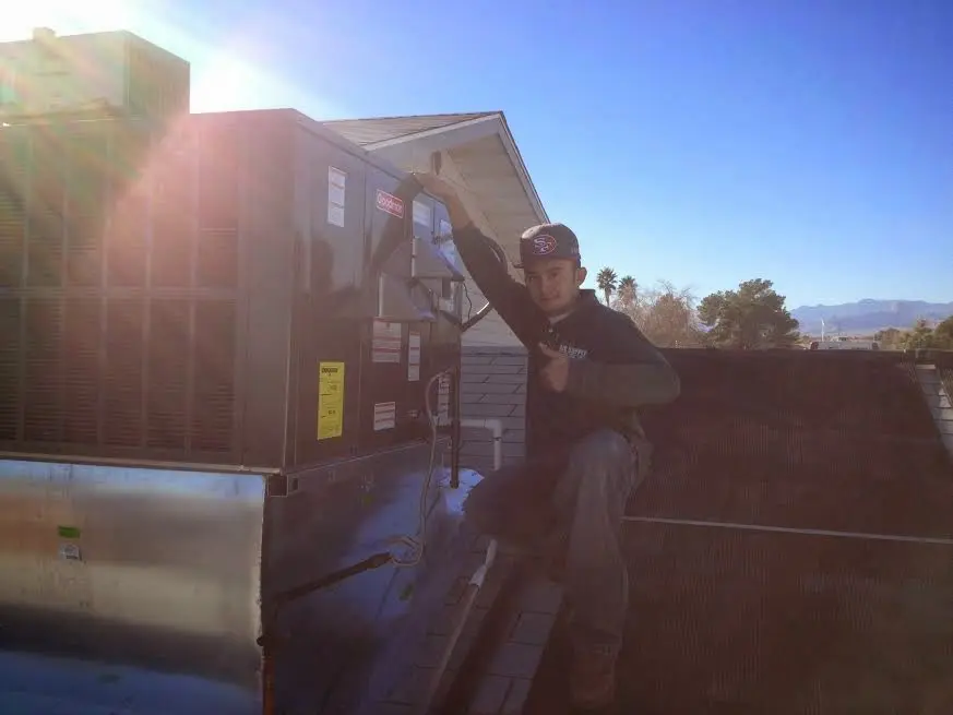 HVAC technician performing HVAC Inspection on a rooftop unit in Park Forest